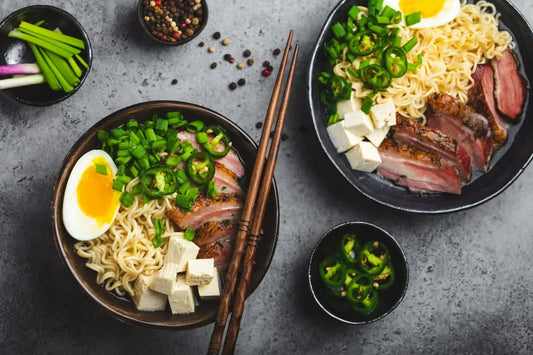 Ramen soup with a soft-boiled egg, green onions, jalapeños, tofu, and grilled pork, garnished with fresh vegetables, perfect for a comforting meal. Explore which vegetables are best for ramen soup